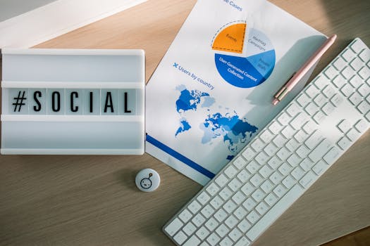 Top view of a desk with social media hashtag, keyboard, and analytics chart in modern design.